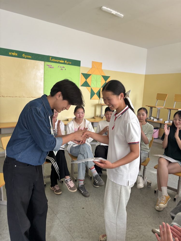 A GRIT EDU student receives a certificate of completion