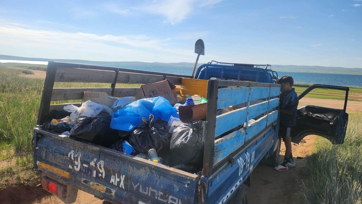 A truck full of waste collected on the shore of Ugii Lake